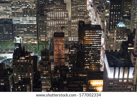 Looking down on Bryant Park and New York City skyscrapers from a high vantage point at night.  Nighttime New York City Skyline.