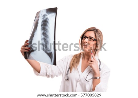 Beautiful young doctor looking at some exams, isolated over white