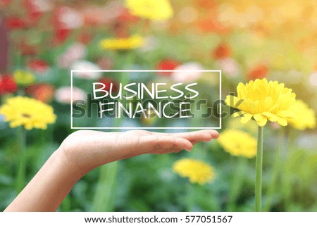 Business Finance word on the white box. concept hand with natural background