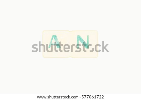 Photo Of Two Green Letters Forming The Word An,  An English Irregular Article, WrittenOn A White Background


