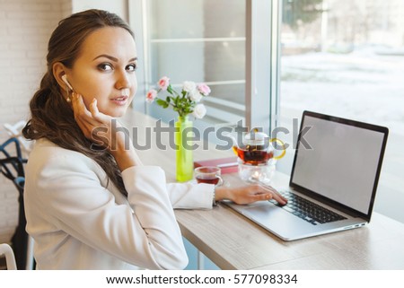 Girl with telephone headset working on computer