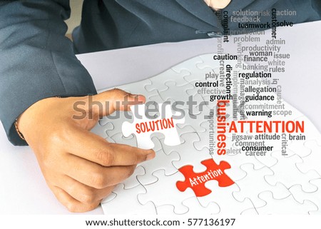 Business woman holding white jigsaw with conceptual text.