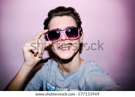 Attractive young man on the colourful background for shopping