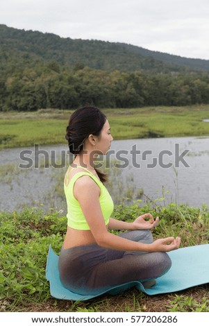 young girl meditates while practicing yoga. freedom, calmness and relax concept, woman happiness