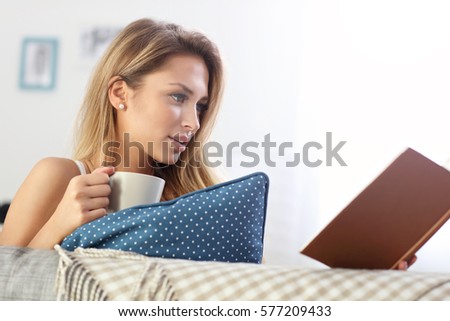 Picture showing happy woman reading on sofa