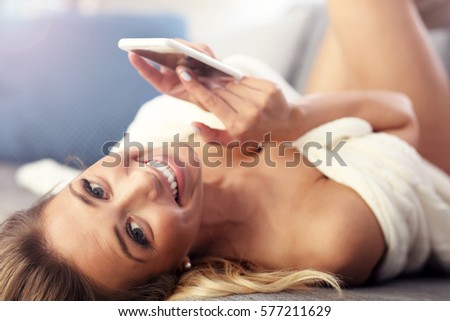 Picture showing happy woman with smartphone on sofa
