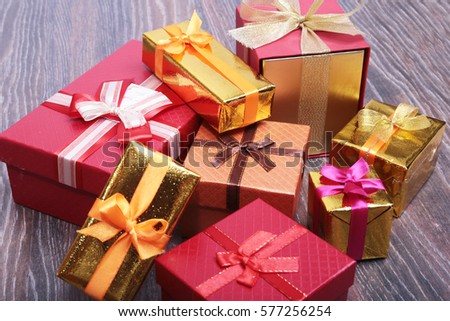 Beautiful gold, red present gift box and ribbons on backgound