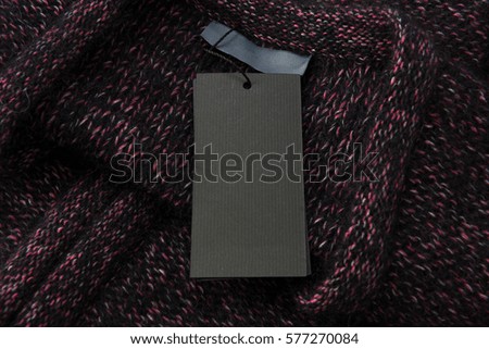 Black Tag and Label on a Knitted Sweater