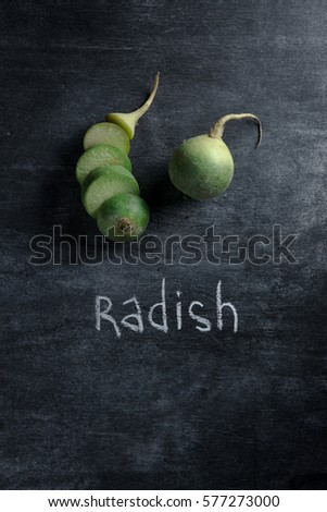 Top view picture of the cut radish over dark background