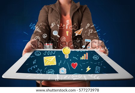 Casual young woman holding tablet with colorful applications