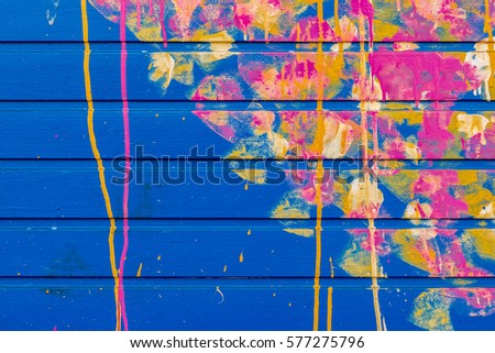 Blue Garage Wall with Pink, Yellow, and Orange Spray Paint Design in London, England