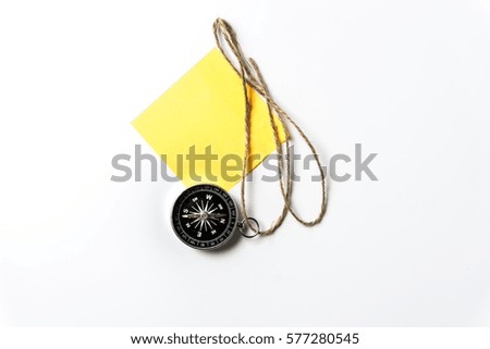 Compass with vintage rope and yellow sticky note isolated over white background. Copy space for add text.