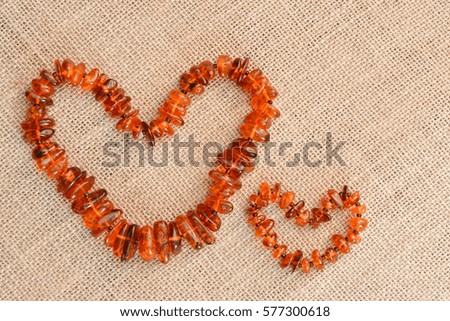 Beads from natural amber on a background of burlap.