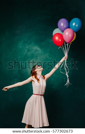 Air balloons flying and a girl