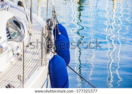 Luxury sailing boat yacht at marina harbor. Royalty-Free Stock Photo #577325377