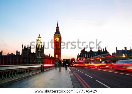 Long exposure of cars and taxis crossing the Westminster bridge with big ben in the background in the evening
