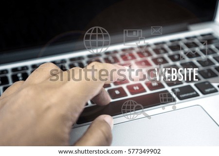 Close up of hand touch keyboard with text WEBSITE and flare effect on image
 