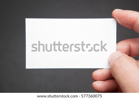hand hold empty business card on black backrounds