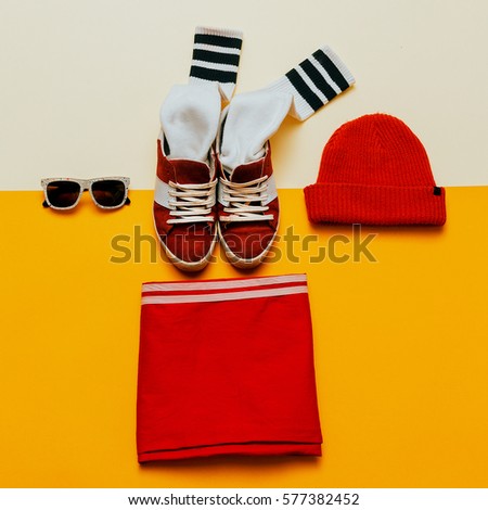 Urban Style Clothing. Skateboard fashion outfit. Sneakers, stockings, hat. Focus on red