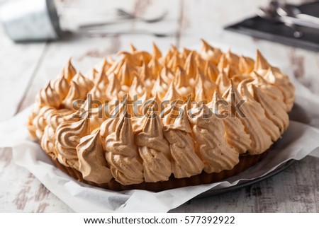 Meringue pie on a wooden table