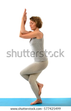 Young yoga woman engaged in yoga. Isolated on white background