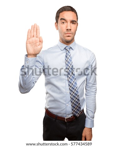 Serious young man doing a stop gesture