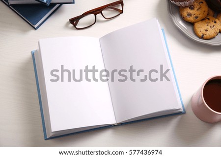 Open book on white wooden table