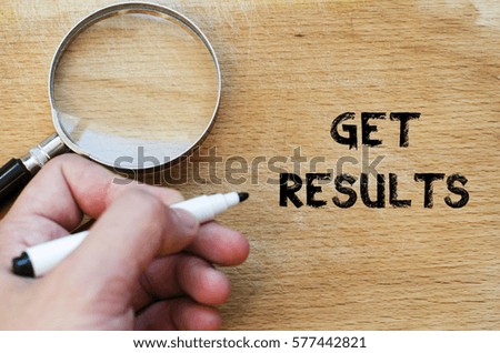 Human hand over wooden background and get results text concept