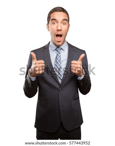 Satisfied young businessman doing an approval gesture