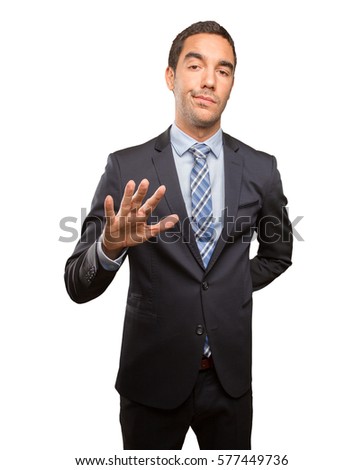 Serious young businessman doing a keep calm gesture