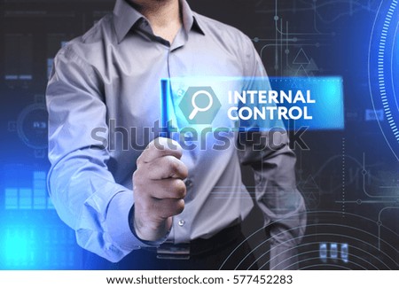 Business, Technology, Internet and network concept. Young businessman showing a word in a virtual tablet of the future: Internal control