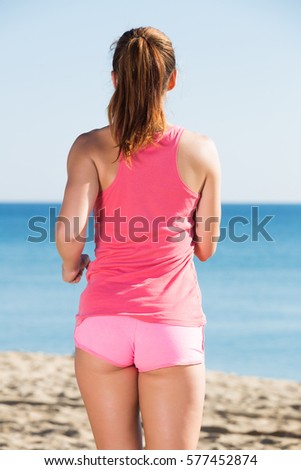 Young brunette woman working out in beach