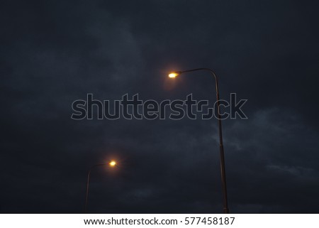 Streetlights in front of very dramatic sky. Royalty-Free Stock Photo #577458187