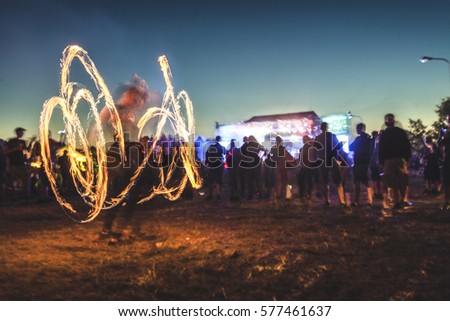 Fire show on music festival. Royalty-Free Stock Photo #577461637