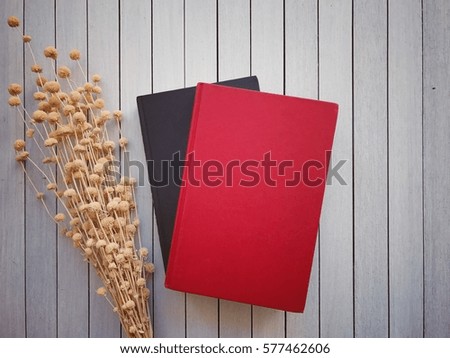 Books and dry flowers put on the wooden background. Vintage style