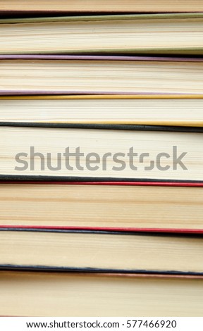 a stack of colorful books in a library or a room