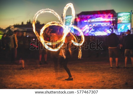 Fire show on music festival. Royalty-Free Stock Photo #577467307