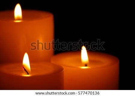 Candles burning at night. Candle light on black background