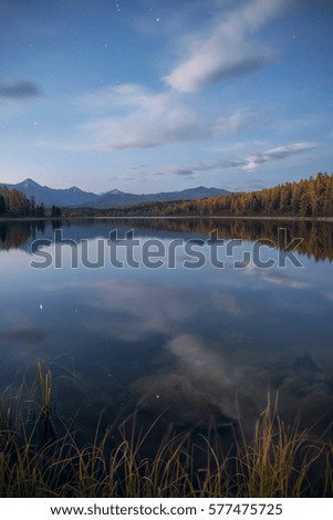 Mirror Surface Lake Vertical Orientation Autumn Landscape With Mountain Range In Early Eveing With Stars On The Sky