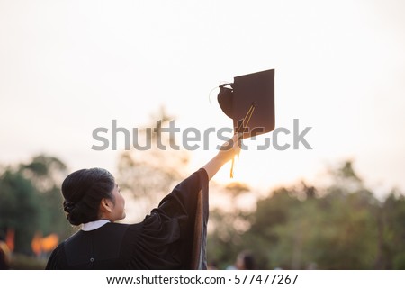 Graduates of the University,Of graduates holding hats handed to the sky,
Education concept.