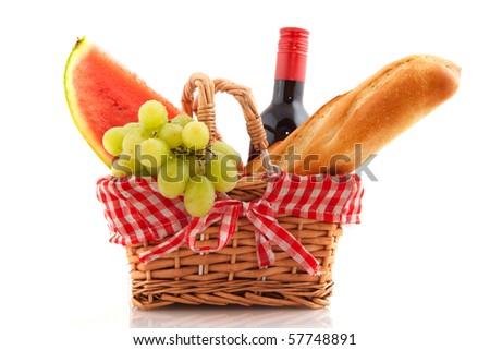 Picnic basket with bread wine grapes and water melon