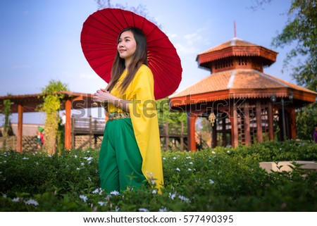 Thai woman dressing with  umbrella traditional style