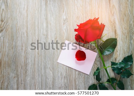 Roses , hearts with Gift box and red ribbon on wood board, Valentines background, wedding day. Love Concept. Valentines day Card with red hearts on wood background. selective focus and color filter