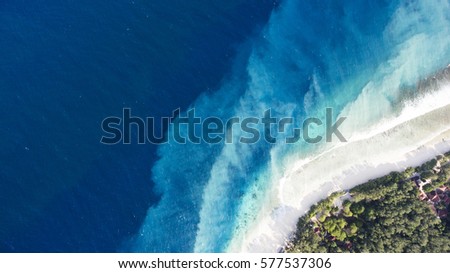 Top view aerial drone photo of one of the most beautiful beaches in the world, incredibly beautiful blue water makes a fascinating picture while ocean current carries the white sand seabed. Background
