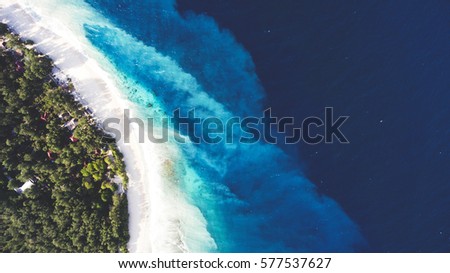Top view aerial drone photo of unspoiled, deserted, powder-white sandy seashore with crystalline water. One of the most beautiful beaches in the world for travel website or journey blog background