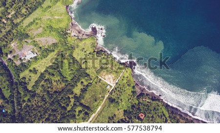 Aerial drone photo top view of the Indian Ocean waves meet or occur with a large white sand beach. Rich beautiful color water as a background for travel blog or web site. Amazing nature landscape