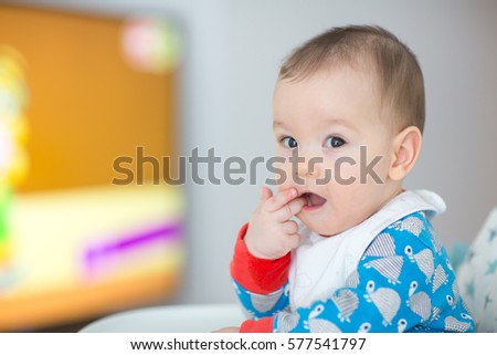 Baby watching cartoons on TV (6 months old).