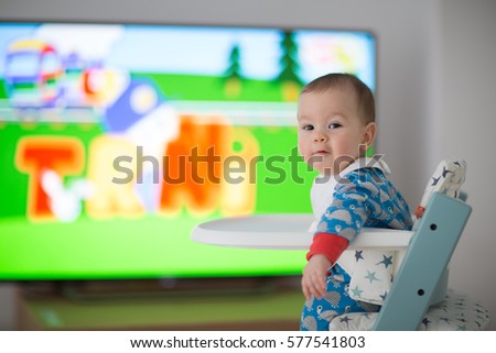 Baby watching cartoons on TV (6 months old).