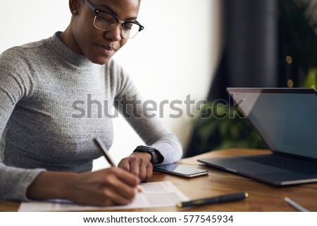 Experienced afro American female owner of business signing contract with corporation for making rebranding campaign to attract customers choosing best professional experts in online database        