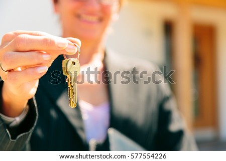 Realtor Giving You The Key To Your New Home